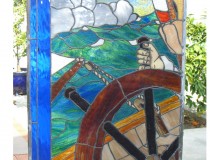 stained glass window of sailor at wheel