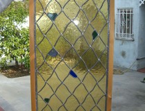 wavy diamond staind glass window with arched top