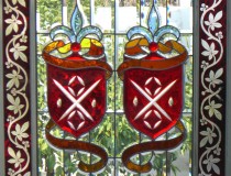 red and blue crest beveled stained glass window