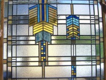 art deco window with indian breast plate design